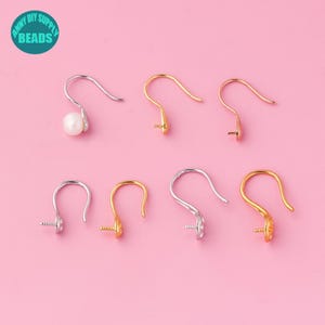 May include: Six earring hooks in silver, gold, and rose gold. The hooks are designed for attaching beads or other jewelry components.