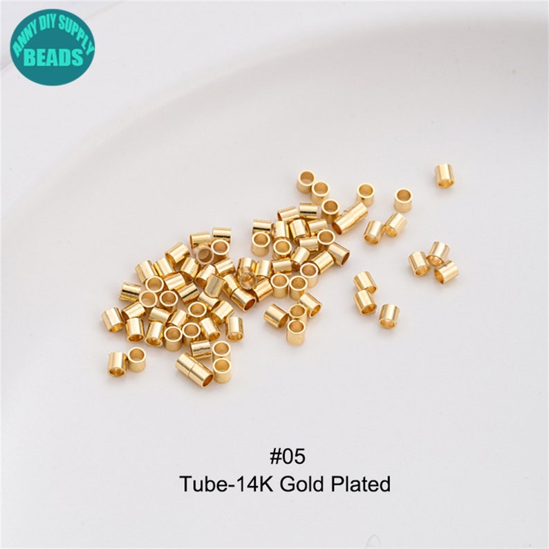 May include: A close-up image of a pile of small, gold-plated metal tubes. The tubes are approximately 6mm in diameter and 12mm long. The image is labelled with the text "#05 Tube-14K Gold Plated".