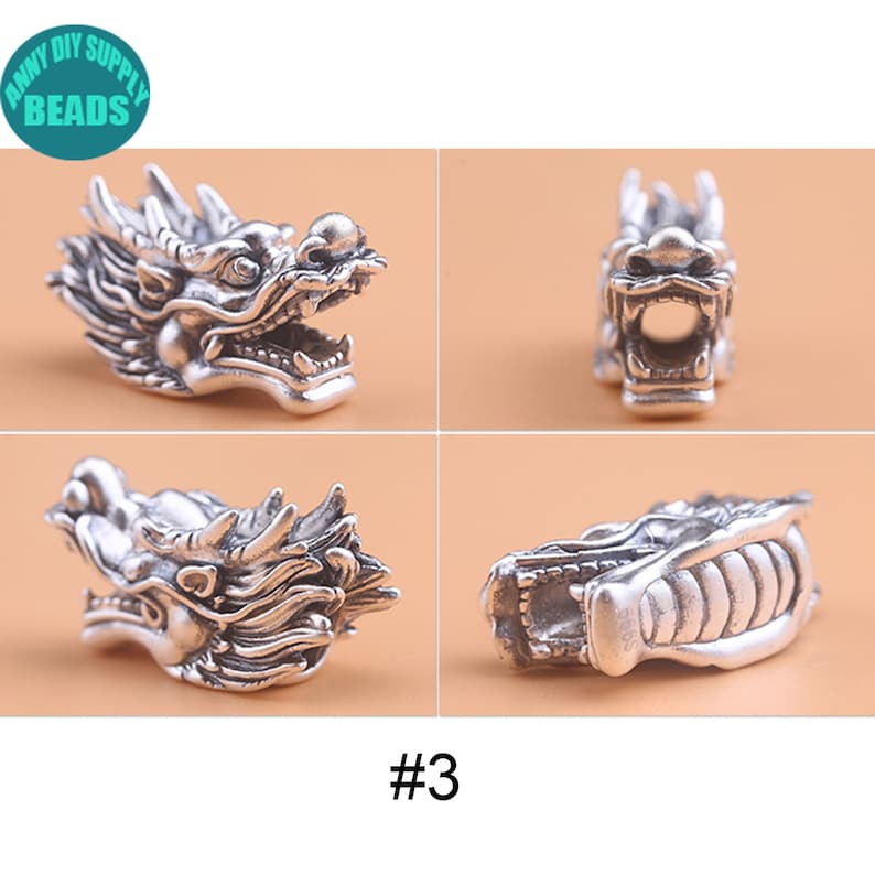 May include: Silver dragon head charm with intricate details. The charm is shown from four different angles, including the front, side, and back. The charm is a popular choice for jewelry making and crafting.