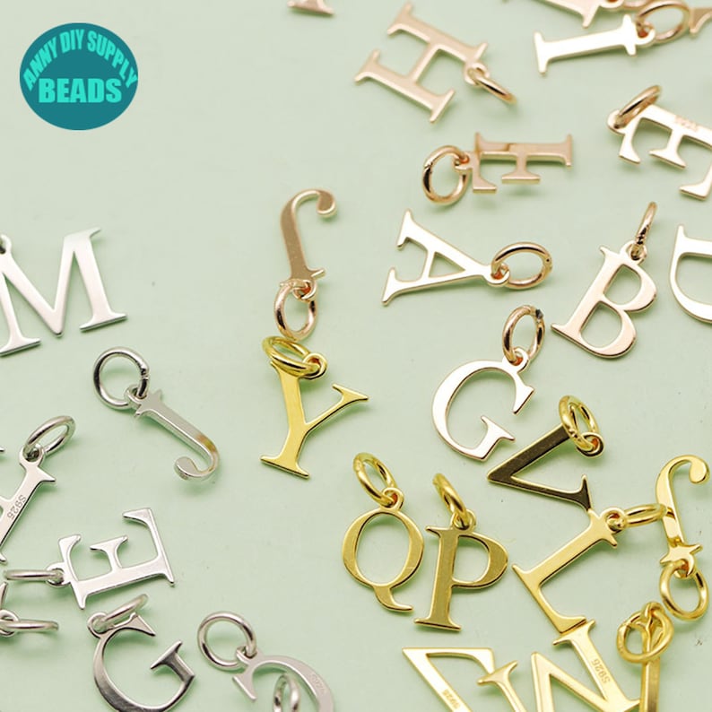 May include: Assortment of gold, silver, and rose gold letter charms. The charms are in the shape of the letters A, B, C, D, E, F, G, H, I, J, K, L, M, N, O, P, Q, R, S, T, U, V, W, X, Y, and Z. The charms are perfect for adding a personal touch to jewelry.