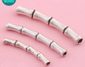 May include: Three silver-toned bamboo-style spacers for jewelry making. The spacers are different sizes and have a smooth, polished finish.