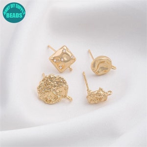 Puede incluir: Cuatro hallazgos de pendientes de tono dorado con diferentes formas. Uno es cuadrado con diamantes de imitación transparentes, uno es redondo y dos son de formas irregulares.