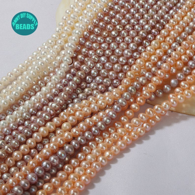 May include: A strand of multiple colors of freshwater pearls. The pearls are round and have a smooth, iridescent finish. The colors range from white to pink to purple.