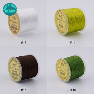 May include: Four spools of elastic cord in different colours: white, yellow, brown, and green. Each spool has a label with Japanese text that says "Polyurethane 100% Made in Japan".