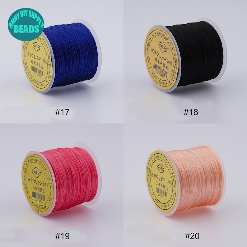 May include: Four spools of elastic cord in different colours: blue, black, pink, and peach. Each spool has a label with Japanese text that says "Polyurethane 100% Japan Crystal Line".
