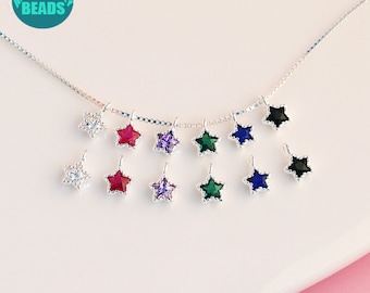 May include: A silver chain necklace with star-shaped charms. The charms are set with clear, red, purple, green, blue, and black crystals.