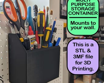 May include: Black multi-purpose storage container mounted on a pegboard, filled with tools like scissors, screwdrivers, and wrenches. The container has text that says "Multi Purpose Storage Container" and "Mounts to your wall."