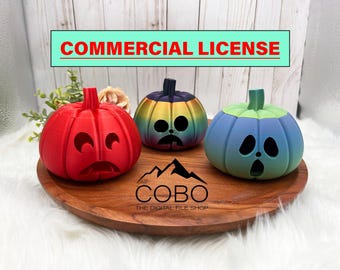 May include: Three 3D printed Halloween pumpkin candle holders. The pumpkins are red, blue, and iridescent with a rainbow gradient. The pumpkins are sitting on a wooden tray with the text "COBO THE DIGITAL FILE SHOP".