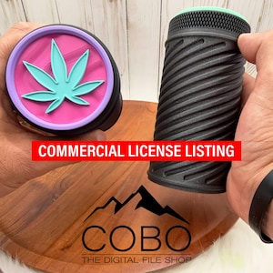 May include: Two black cylindrical containers with a cannabis leaf design. One container has a pink and purple lid with a turquoise leaf. The other has a black, textured exterior. The text "COMMERCIAL LICENSE LISTING" is visible.