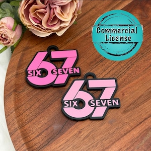 May include: Two pink and black keychains with the number 67 and the words "SIX SEVEN" are displayed. The keychains are on a wooden surface, with a teal "Commercial License" graphic in the background. A large pink and cream flower is in the upper left corner.