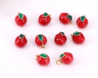 May include: Ten red enamel apple charms with gold-tone metal loops and green enamel leaves. The charms are perfect for jewelry making, scrapbooking, and other craft projects.