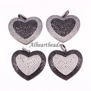 May include: Four black metal heart-shaped pendants with a black and white crystal design.