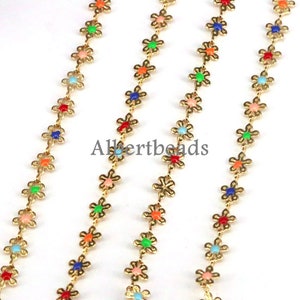 May include: Three strands of gold chain with colorful flower-shaped beads. The beads are in various colors, including red, orange, yellow, green, blue, and purple.