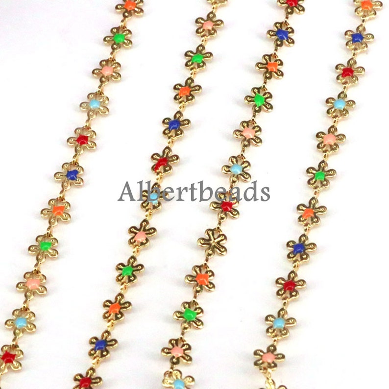 May include: Three strands of gold chain with colorful flower-shaped beads. The beads are in various colors, including red, orange, yellow, green, blue, and purple.