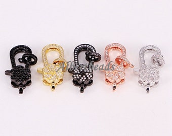 May include: Five lobster claw clasps with a flower design. The clasps are made of metal and are available in black, gold, silver, rose gold, and gunmetal.