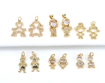 May include: Gold-tone metal charms in the shape of children, some with clear crystal accents. The charms are perfect for jewelry making or adding a personal touch to crafts.