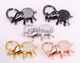 May include: Five elephant-shaped lobster clasps with a clear crystal design. The clasps are available in silver, black, gold, and rose gold.