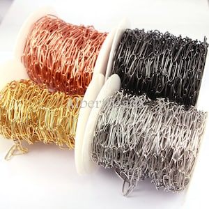 May include: Four spools of chain, each in a different color: gold, silver, rose gold, and black. The chain is made of metal and is perfect for jewelry making.