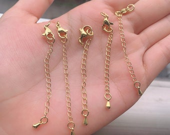 May include: Five gold-toned extender chains with lobster claw clasps and small teardrop-shaped charms.