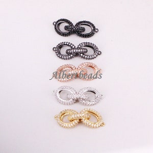 May include: Four different colored metal connector clasps with clear crystal embellishments. The clasps are in black, silver, rose gold, and gold.