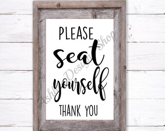 May include: A white sign with a rustic wood frame, featuring the text "PLEASE seat yourself THANK YOU" in black cursive font.