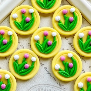 May include: A trio of ceramic mugs with a speckled, matte finish in cream, light grey, and dark grey. Each mug features a simple, minimalist design, ideal for tea or coffee.