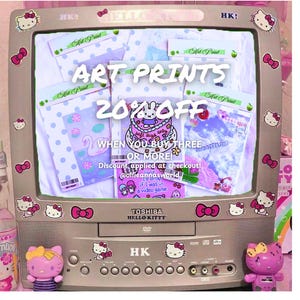 May include: A vintage television decorated with Hello Kitty stickers and bows displays art prints. The screen shows several packaged prints with various designs. Text on the screen reads "ART PRINTS 20% OFF" and other promotional details.