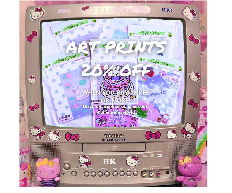 May include: A vintage television decorated with Hello Kitty stickers and bows displays art prints. The screen shows several packaged prints with various designs. Text on the screen reads "ART PRINTS 20% OFF" and other promotional details.