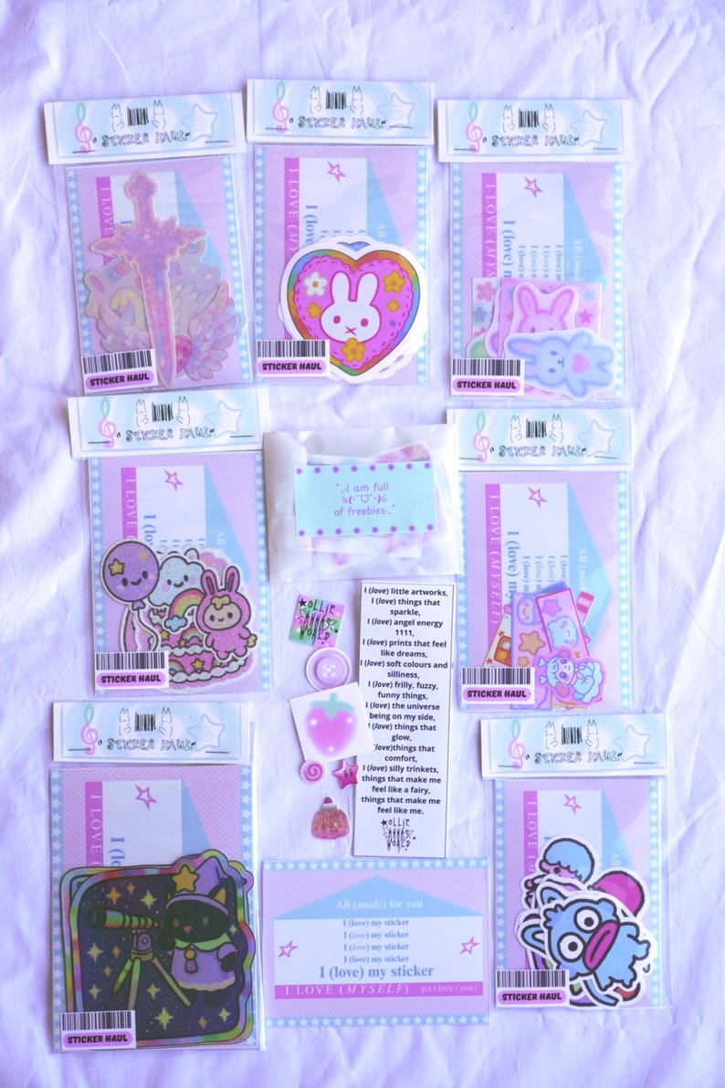 May include: A collection of stickers in various designs, including a sword, a bunny in a heart, and cartoon characters. The stickers are packaged in clear plastic with pink and blue backing cards. Text on the packaging reads "STICKER HAUL" and "I LOVE (MYSELF)".