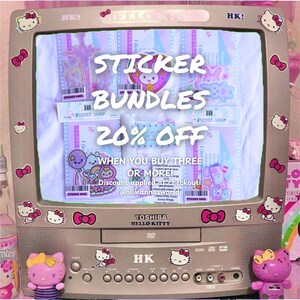 May include: A vintage Toshiba Hello Kitty television decorated with Hello Kitty stickers. The screen displays sticker bundles with a 20% off promotion. The image includes two Hello Kitty figurines and the text "STICKER BUNDLES".