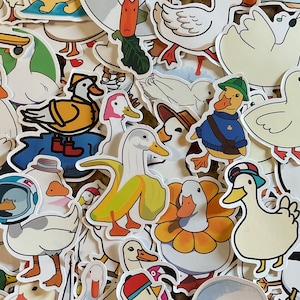 May include: A collection of colorful, cartoon-style duck stickers. The stickers feature various ducks in different poses and with different expressions. Some ducks are wearing hats or sunglasses. The stickers are perfect for adding a touch of whimsy to any project.