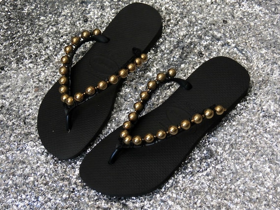 black and gold flip flops