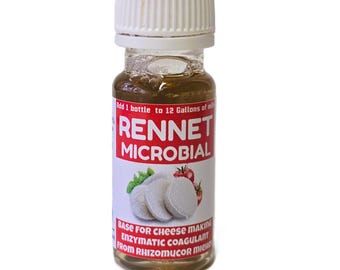 May include: A small glass bottle with a white cap, containing a brown liquid. The label reads "RENNET MICROBIAL" in red and white, with an image of cheese and tomatoes. The text also states it is a base for cheese making.