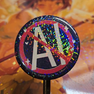 May include: A circular badge with a shimmering, holographic surface. It displays a red circle with a line through the white letter "A", and the text "AI" in white. The badge is mounted on a black stick.