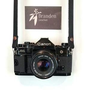 Black Leather Camera Strap. Single rivet and glued camera strap for your film or digital camera. Variable fixed length design.