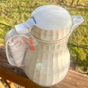 May include: A set of three ceramic mugs with a speckled, matte finish in cream, light grey, and dark grey. Each mug has a minimalist design, ideal for coffee or tea.