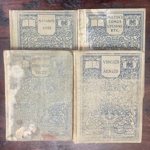 May include: Four vintage books with light blue covers and ornate designs. Titles include "Plutarch's Lives," "Milton's Comus Lycidas Etc.," "Hawthorne's Tanglewood Tales," and "Virgil's Aeneid." The books are part of the Macmillan Pocket Classics series.