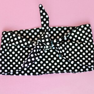 May include: Black and white polka dot headband tied in a bow.