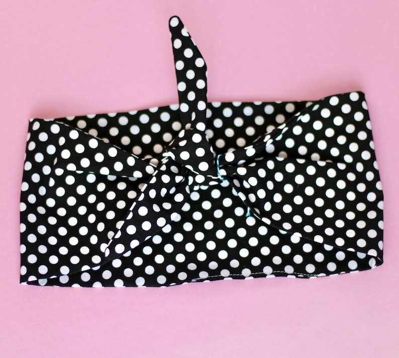 May include: Black and white polka dot headband tied in a bow.