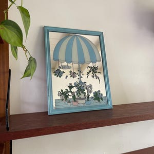 80s, eighties mirror with Helen, a parasol and flowers / flower pots. Blue wooden frame