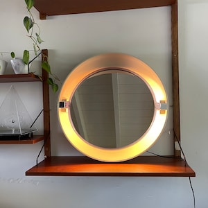Allibert Italian design round Space age mirror with lighting from the 70s. Spage age lamp with mirror and socket. Tiltable