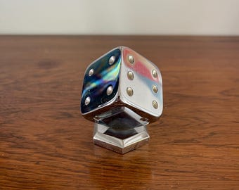 Metal dice on a stand, paperweight. Heavy vintage iron item, decorative game element.