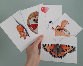 5 postcards with prints of watercolour illustrations of a hippopotamus, hedgehog, fox, butterfly and penguin.