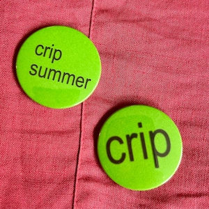 May include: Two bright green circular badges with black text on a red background. One badge says "crip summer" and the other says "crip". These badges are likely for clothing or accessories.