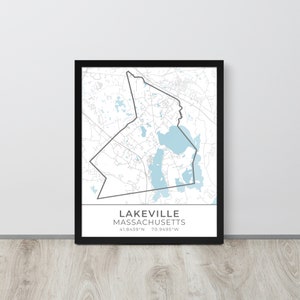 May include: Framed map print of Lakeville, Massachusetts, with a black border. The map features a detailed outline of the town, with light blue areas representing bodies of water. The text "LAKEVILLE MASSACHUSETTS" is displayed below the map, along with the coordinates.