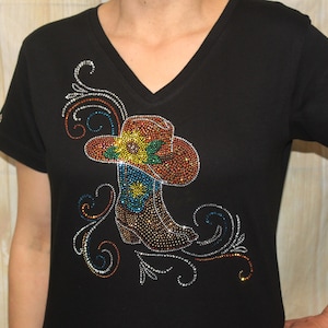 May include: Black t-shirt with a rhinestone design of a cowboy boot and hat with a sunflower detail.