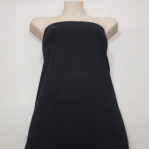 May include: A black fabric draped over a mannequin. The fabric is smooth and appears to be a solid color. The mannequin is a neutral skin tone, and the background is a plain white.