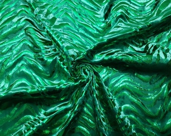 May include: Green fabric with a wavy, striped pattern. The fabric is shiny and has a metallic sheen.