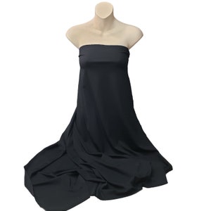 May include: A black strapless dress displayed on a mannequin. The fabric drapes down, creating soft folds and a flowing effect. The dress is made of a smooth, solid-colored material.
