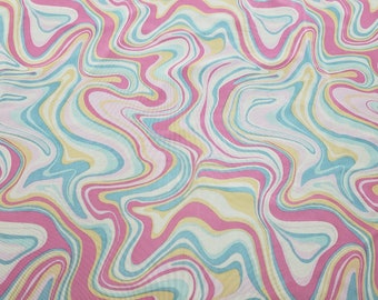 May include: Abstract fabric with a swirling pattern in shades of pink, blue, yellow, and white.